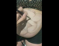 Woman paints art on pregnant womans belly 