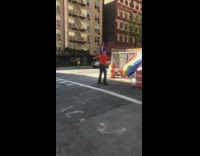 Purple witch hat guy dances rainbow flag