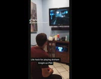 Guy puts tape on video game controller 