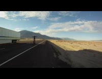 Black jacket guy stands on red motorcycle 