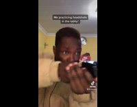 Guy practices headshots in hotel lobby 