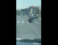 Woman sits at guy riding mobility scooter