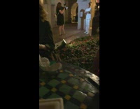 Man in white outfit performs for a video shoot