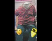 Mannequin no head no arms red plaid shirt jeans sits on subway train