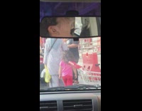 Little girl pink shirt red shorts outside car flips hair