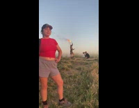 Woman with fire props poses on the hill