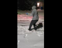 Man gray hoodie snowboarding pulled by truck