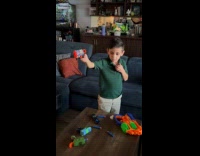 Kid removing loose tooth using nerf gun