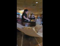 Woman takes a video of the employee that makes the guacamole