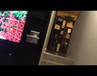 Guy in orange shirt runs up small stairs and trips in front of stariway