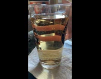 Person put finger behind ginger ale glass