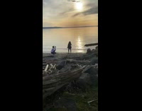 Girl poses for photo on beach shore 