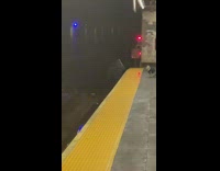Guy walks subway track to close box