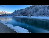 Man throws stone over freshly frozen lake