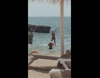 Guy red short dab look upward beach