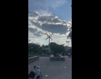 Topless woman lay on ledge windmills
