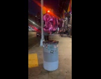 Collab WINY - Two floating balloons tied to trash can