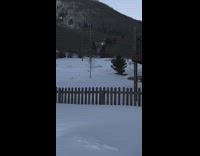 Guy jumps off small ramp on snowboard and faceplants in snow