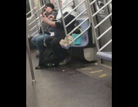 Guy wearing bunny rabbit  ears playing ukulele and singing in subway train