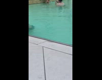 Woman bikini swimming pool arms spread fountain