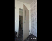 Girl black shirt jeans walks out of door comes back