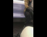 Man in green brown jacket smokes weed and does drugs on the subway