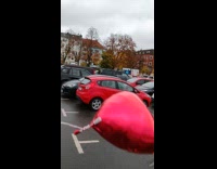 Red heart balloon released in the air