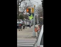 Guy does pull ups on stop light