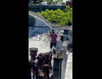 Man checkered shirt play ukulele on rooftop