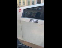 Cybertruck parked on street full of stickers