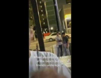 Guy drinking at the bar records his underage friends standing outside