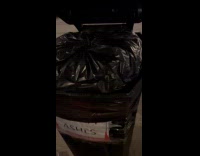 Two trash bin with sign says Ashes