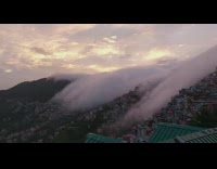 Clouds pass over mountain buildings time lapse music