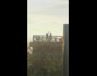 Two girls arm up rooftop sunset silhouette