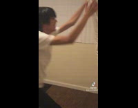 Guy drops rug on floor and then bed on it