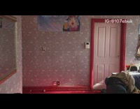 three guys in wetsuits market drinking