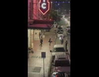 Three men black shirt dance entrance sidewalk