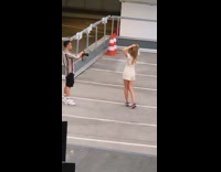 Girl white shorts hold hair traffic cone