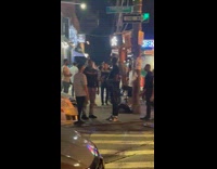 Shirtless man do pull ups on pedestrian lights