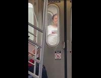 Man white shirt smoke cigarette between train 