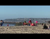 Woman livestream santa costume beach cart jetty