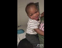 Baby twerks on mom while smiling