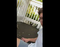 Guy sits on balcony feeds squirrel nuts 