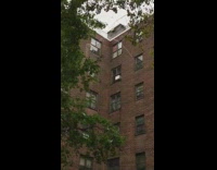 Stream of water comes out apartment window