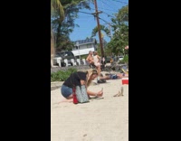 Black shirt lady beach gold flip flops 