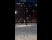 Guy walk with skis at park night
