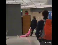 Dad dragging daughter by the hood through airport