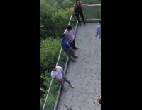 Multiple people balcony viewpoint overlooking lake water