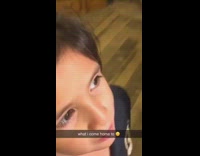 Little girl puts sign on water bottle in refrigerator 