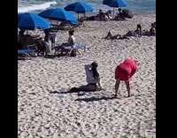 Woman in gray jacket and black underwear kneels